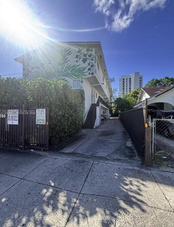 A multi-story apartment building features a large botanical mural on its side wall — 560 NW 1st St # 7, Miami FL 33128, MIAMI, FL