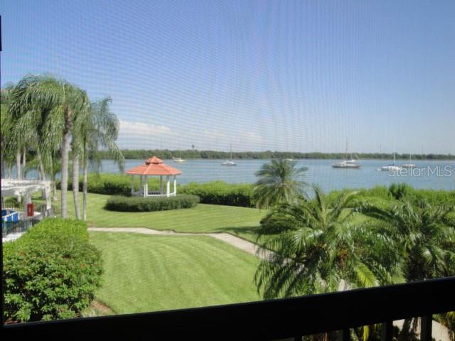 A view from a screened balcony overlooking a grassy lawn, a gazebo, and a bay — 6295 BAHIA DEL MAR CIRCLE UNIT 216, ST PETERSBURG, FL