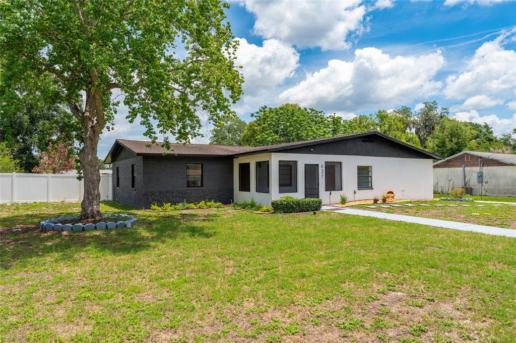A single-story house with a white and dark brick exterior stands on a grassy lot — 637 PASADENA AVENUE, LONGWOOD, FL