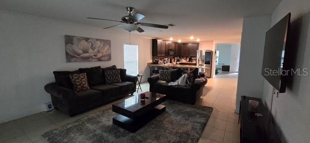 A kitchen features dark cabinets, granite countertops, and a tiled breakfast bar — 1528 E FALMOUTH AVENUE, DELTONA, FL