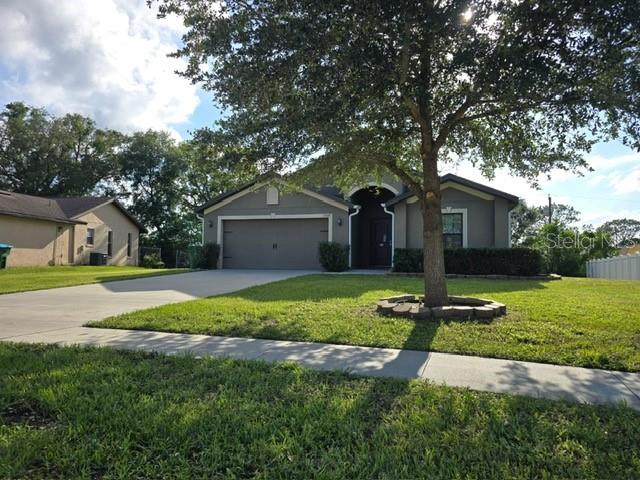 A kitchen features dark wood cabinets, granite countertops, stainless steel appliances, and tile flooring — 1528 E FALMOUTH AVENUE, DELTONA, FL
