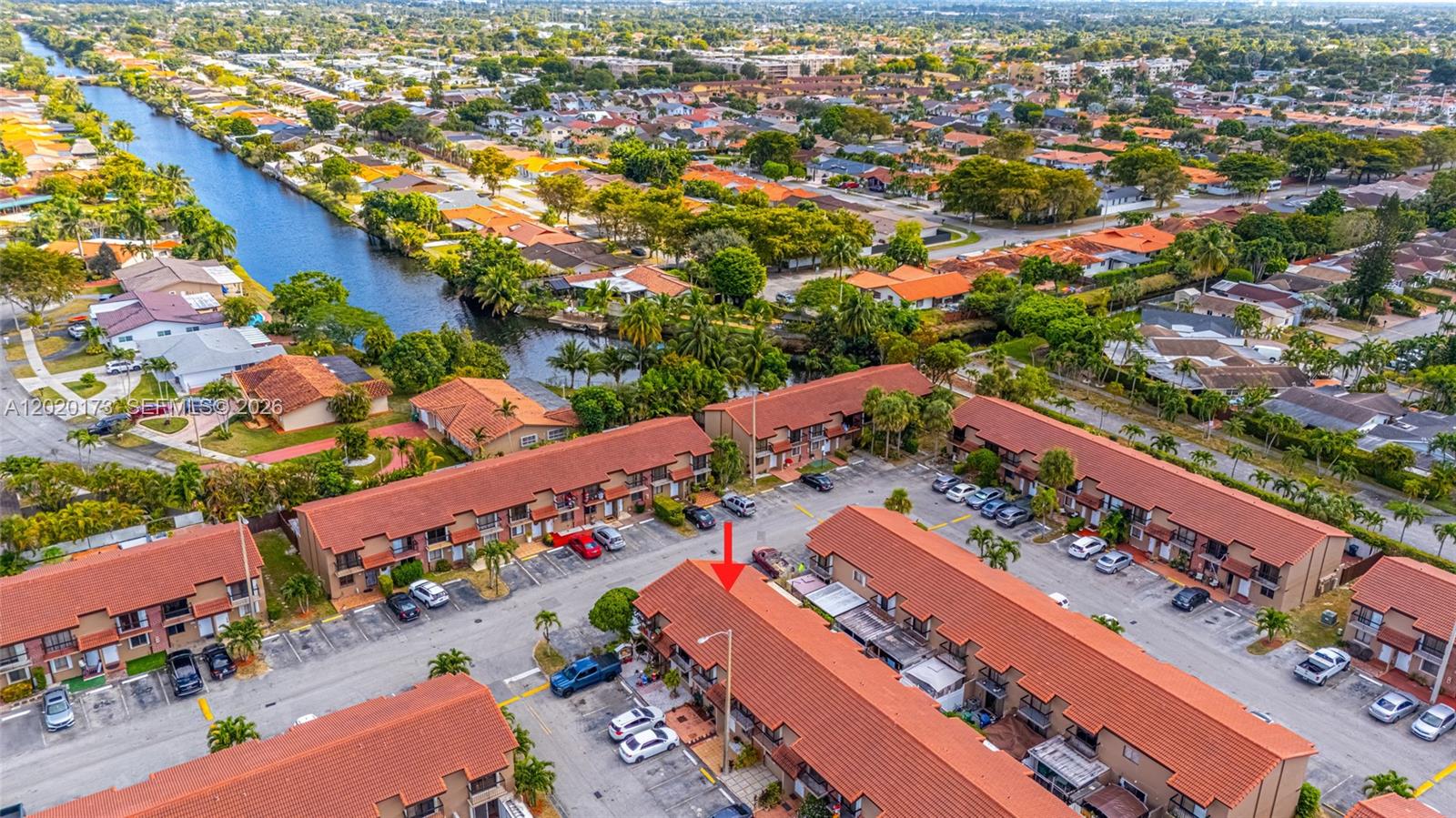 An aerial view shows a multi-unit residential complex with red tile roofs and parking — 1911 SW 107th Ave # 1009, Miami FL 33165, MIAMI, FL