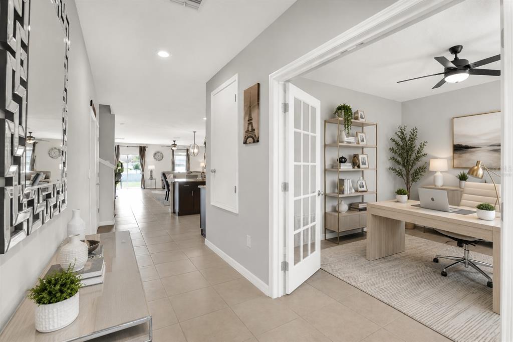 A hallway leads to an open living area past a home office with French doors — 13524 WILD GINGER STREET, RIVERVIEW, FL
