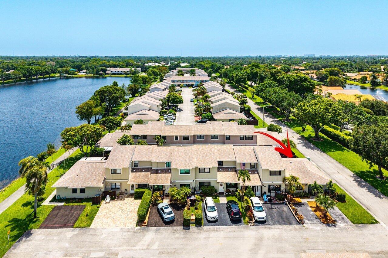 An aerial view shows a row of townhouses with a red arrow pointing toward one unit — 16422 Straw Way, Delray Beach FL 33484, DELRAY BEACH, FL