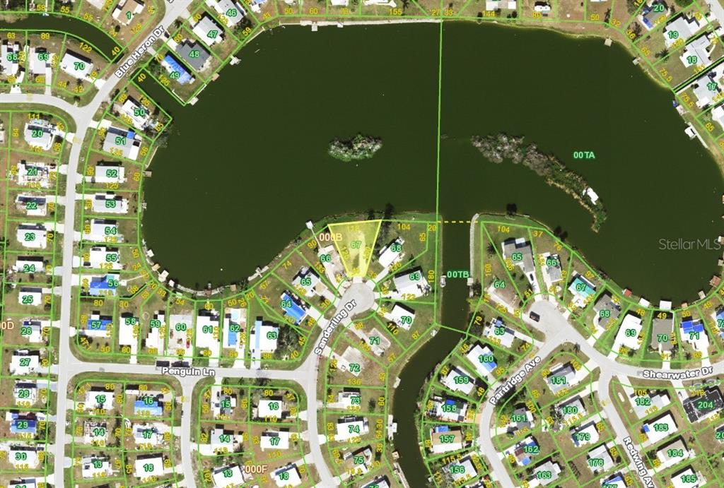 This is a satellite map showing a residential neighborhood surrounding a large lake — 1303 SANDERLING DRIVE, ENGLEWOOD, FL