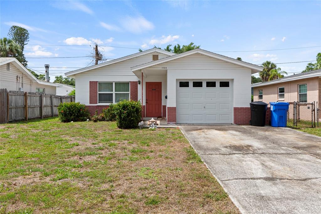 A single-story house with a white facade, red brick accents, and an attached garage — 1735 MISSISSIPPI AVENUE NE, ST PETERSBURG, FL