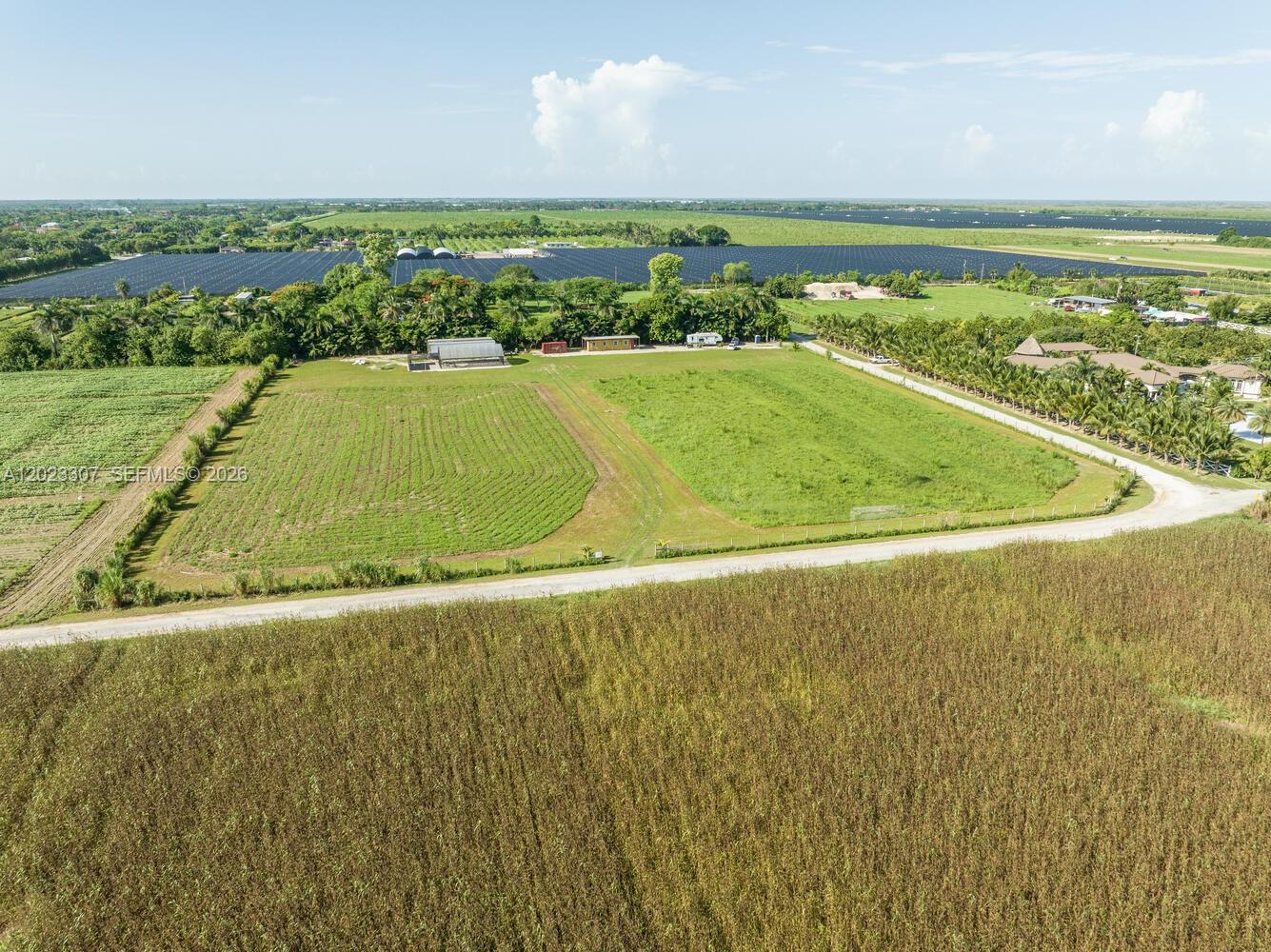 An aerial view shows a large, flat plot of land with cultivated fields and structures — 21750 SW 226 Terrace, Miami FL 33170, MIAMI, FL