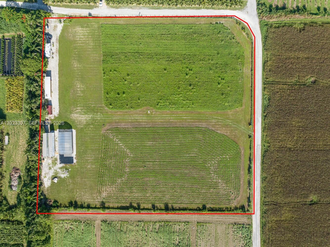 An aerial view shows a rectangular plot of land with structures and cultivated fields — 21750 SW 226 Terrace, Miami FL 33170, MIAMI, FL