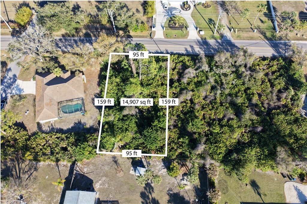 An aerial view shows a rectangular, wooded vacant lot with dimensions marked on the image — 0 MANASOTA BEACH ROAD, ENGLEWOOD, FL