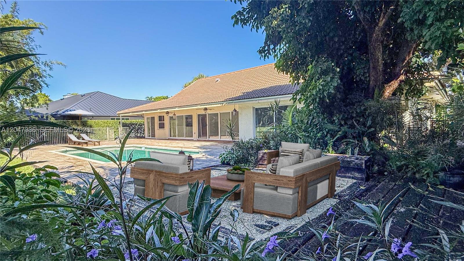 A backyard patio features a swimming pool, a house with sliding doors, and outdoor furniture — 10134 Boca Woods Ln # 1034, Boca Raton FL 33428, BOCA RATON, FL