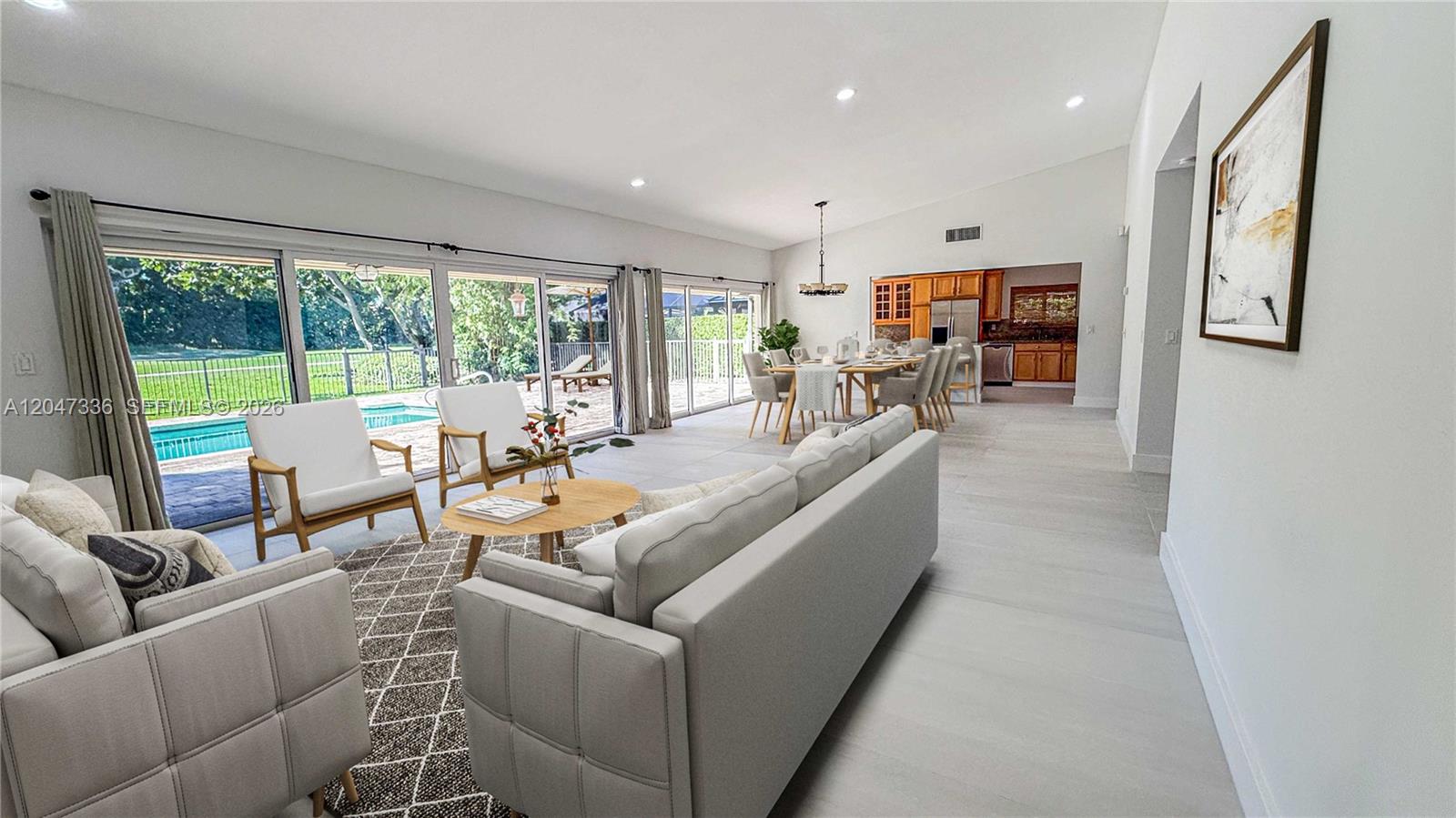 A spacious open-concept living and dining area features tile floors and large sliding glass doors — 10134 Boca Woods Ln # 1034, Boca Raton FL 33428, BOCA RATON, FL