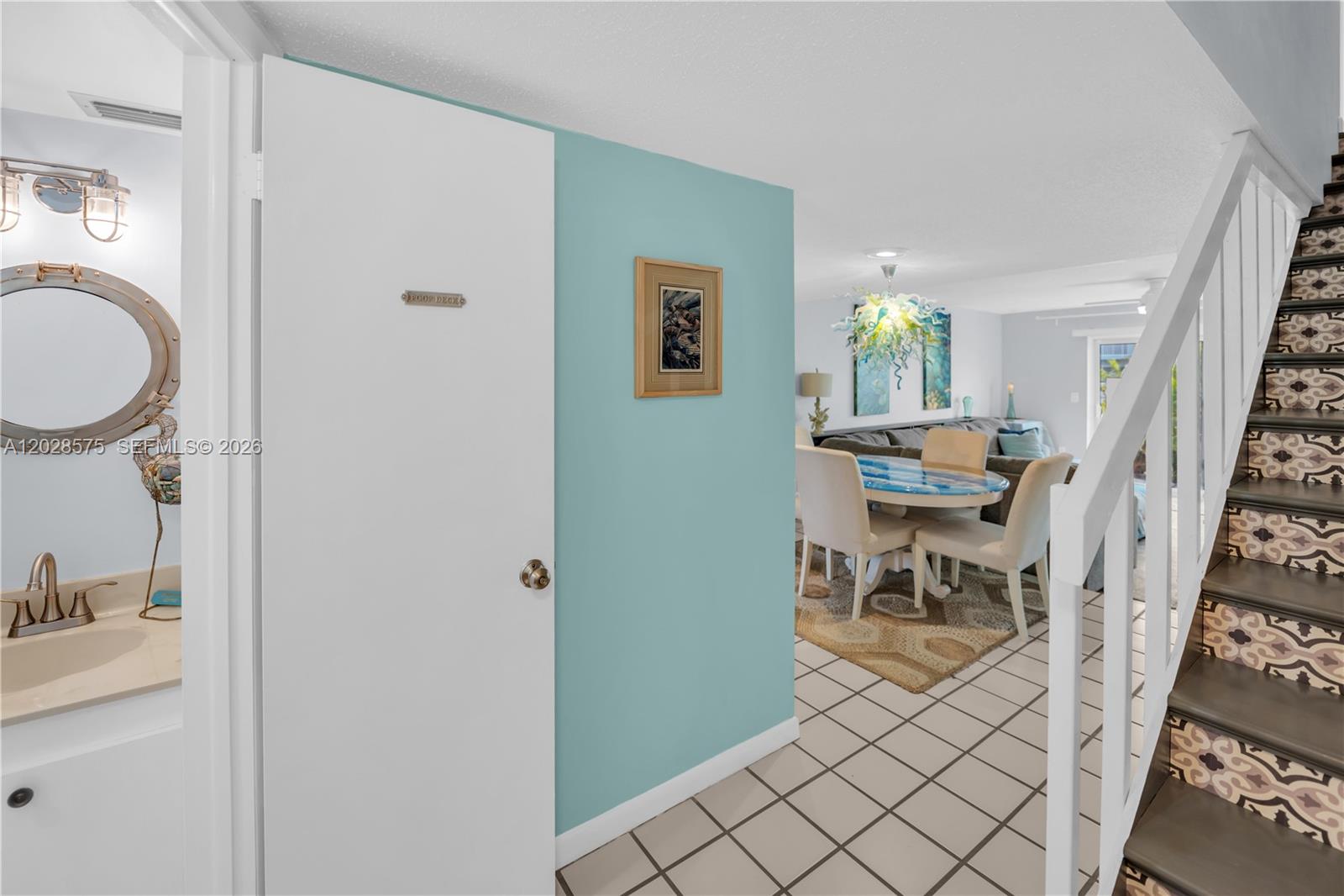 A hallway with a tiled floor leads to a dining area and a staircase — 40 High Point Rd # 402, Islamorada FL 33070, ISLAMORADA, FL