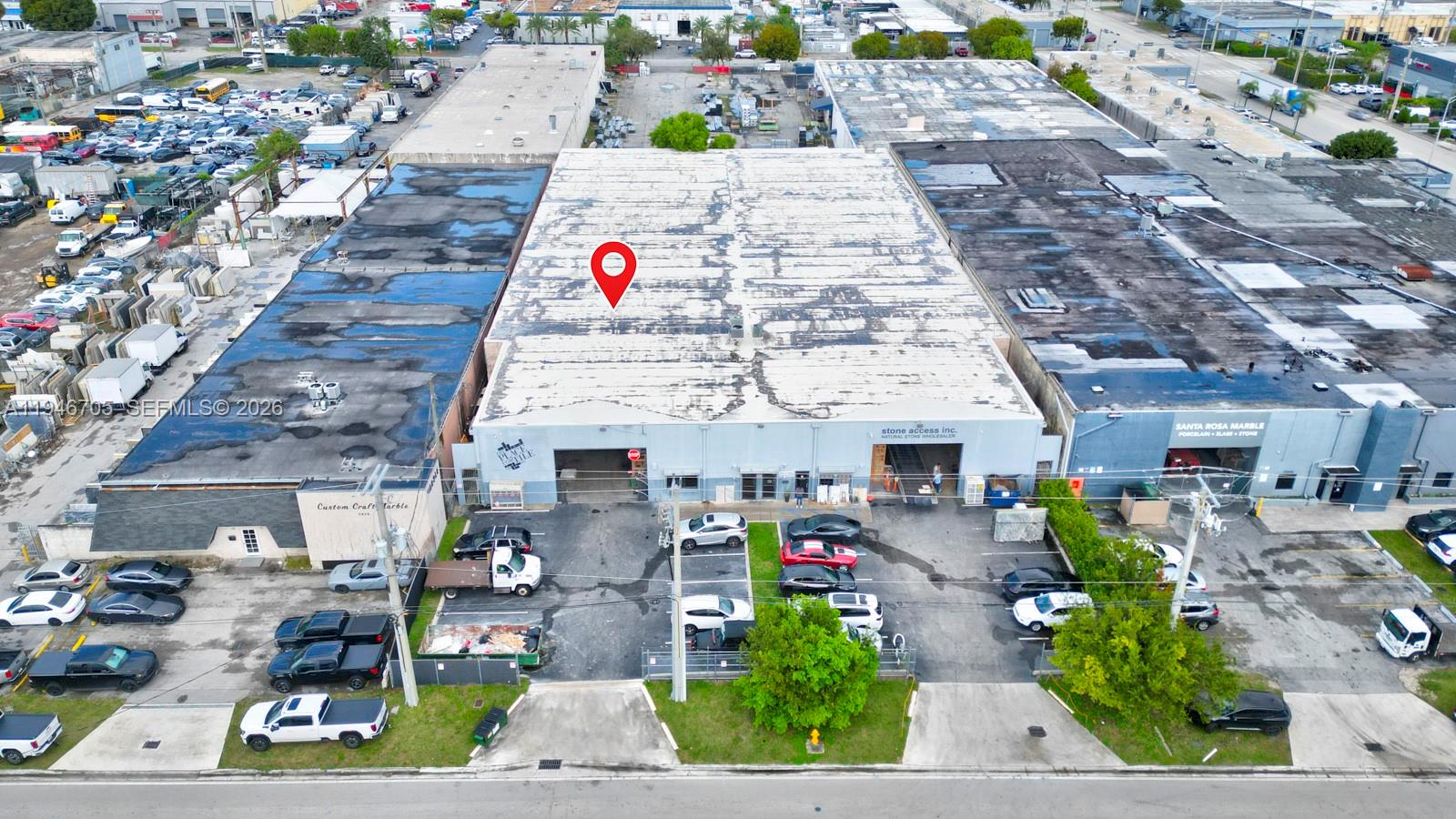 An aerial view shows a commercial warehouse building with a parking lot in front — 7957 NW 54th St, Doral FL 33166, DORAL, FL