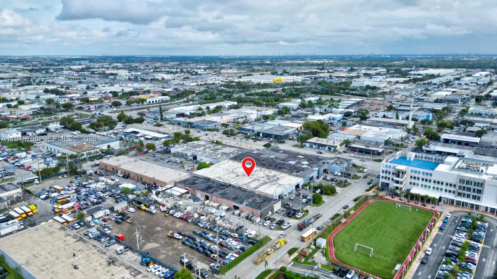 An aerial view shows a warehouse building with a red location pin on its roof — 7957 NW 54th St, Doral FL 33166, DORAL, FL