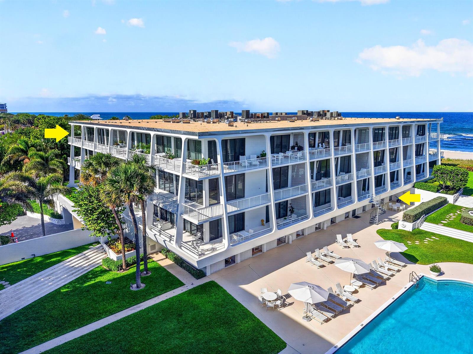 An aerial view of a multi-story white apartment building with balconies next to a pool — 2275 S Ocean Boulevard # 305n, Palm Beach FL 33480, PALM BEACH, FL