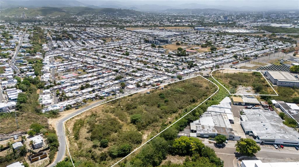 An aerial view shows two adjacent vacant lots of land situated next to commercial buildings — 1 REPARTO INDUSTRIAL, PONCE, PR