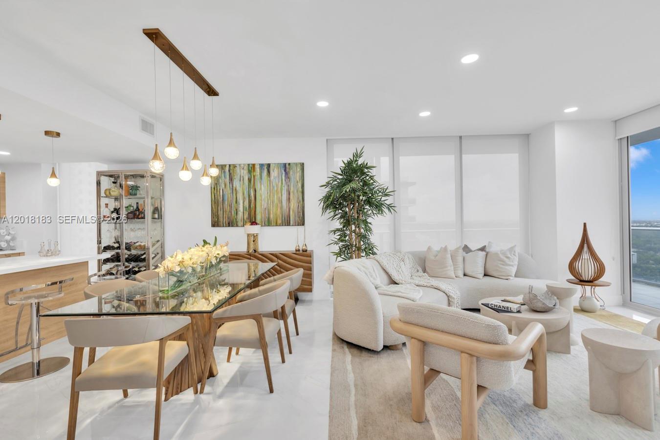 A modern open-concept living and dining area features neutral furniture, glass tables, and floor-to-ceiling windows — 16385 Biscayne Blvd # 2101, North Miami Beach FL 33160, NORTH MIAMI BEACH, FL