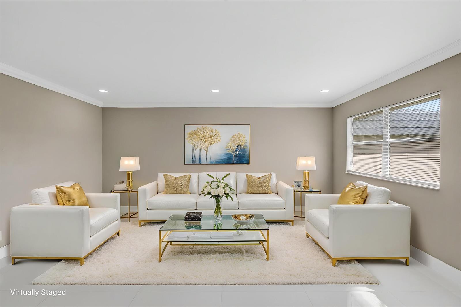 This is a virtually staged living room featuring white leather furniture, gold accents, and neutral walls — 429 Flanders I, Delray Beach FL 33484, DELRAY BEACH, FL