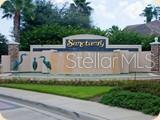 A stone monument sign for The Sanctuary community features metal bird sculptures and landscaping — 36 OLD OAK DRIVE S, PALM COAST, FL