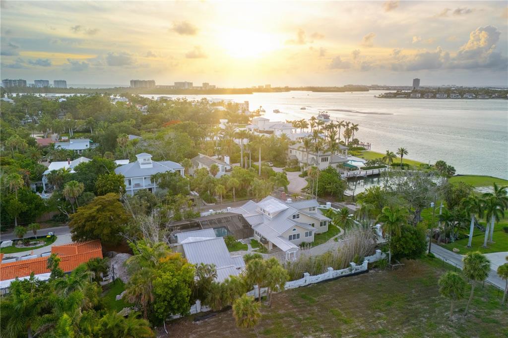 An aerial view of a coastal home with a metal roof surrounded by lush tropical landscaping — 604 NORSOTA WAY, SARASOTA, FL