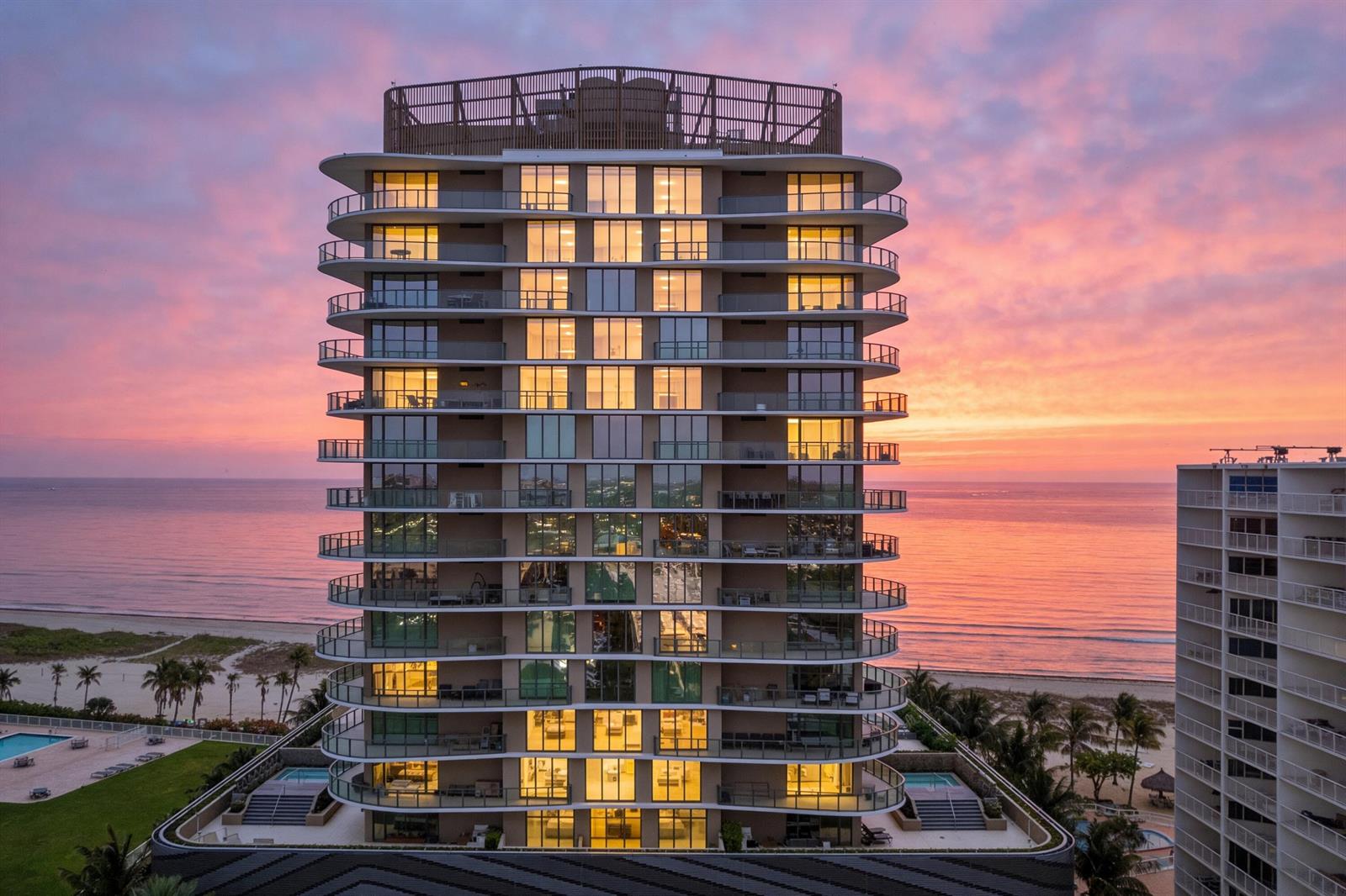 An aerial view of a modern high-rise residential building at sunset by the ocean — 730 N Ocean Boulevard # 505, Pompano Beach FL 33062, POMPANO BEACH, FL