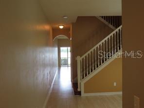 A hallway leads toward a glass door with a staircase on the right — 3903 45TH TERRACE W UNIT 104, BRADENTON, FL