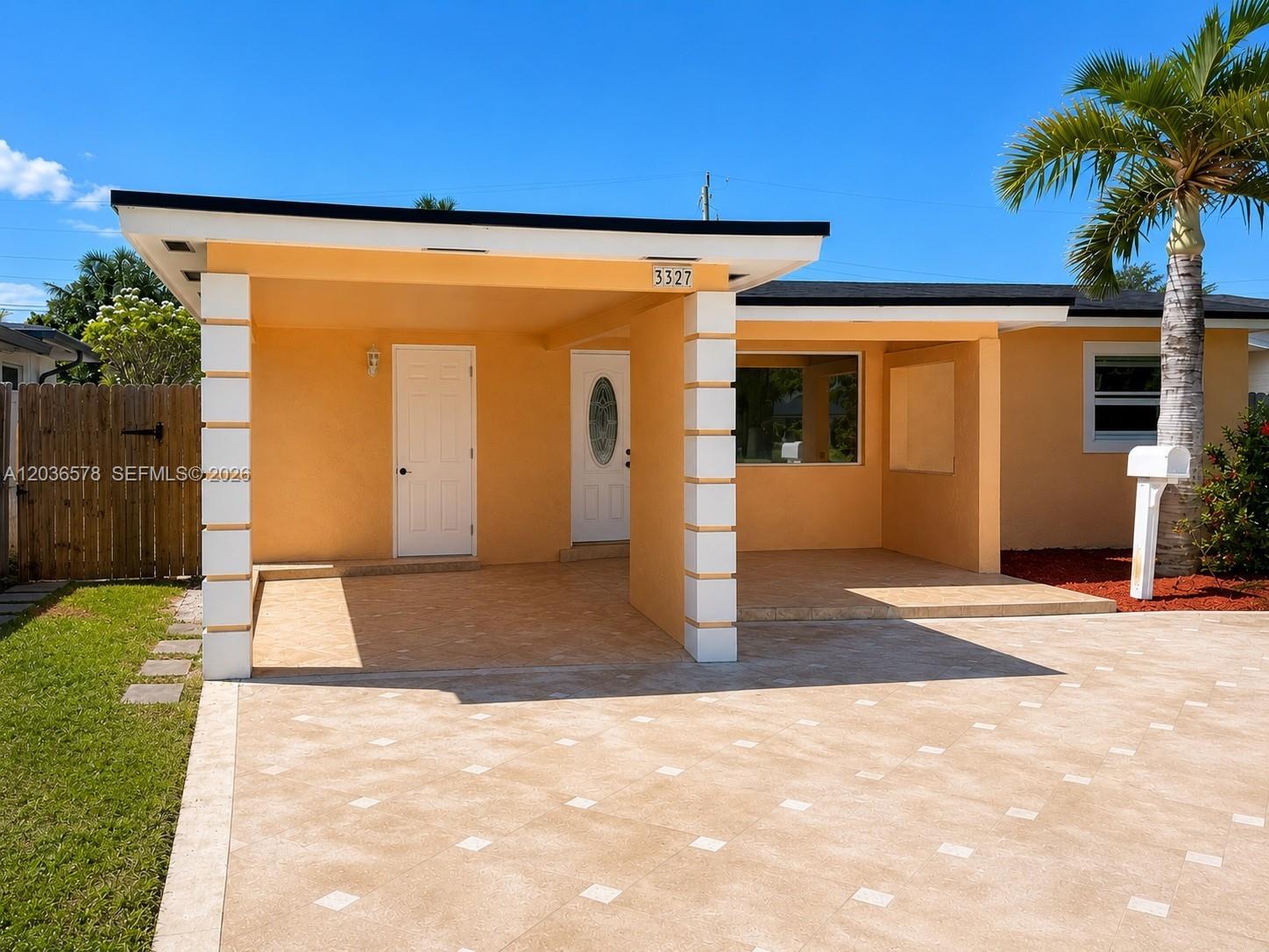 A single-story house features a tan stucco exterior, a covered carport, and a paved driveway — 3327 Taft St, Hollywood FL 33021, HOLLYWOOD, FL