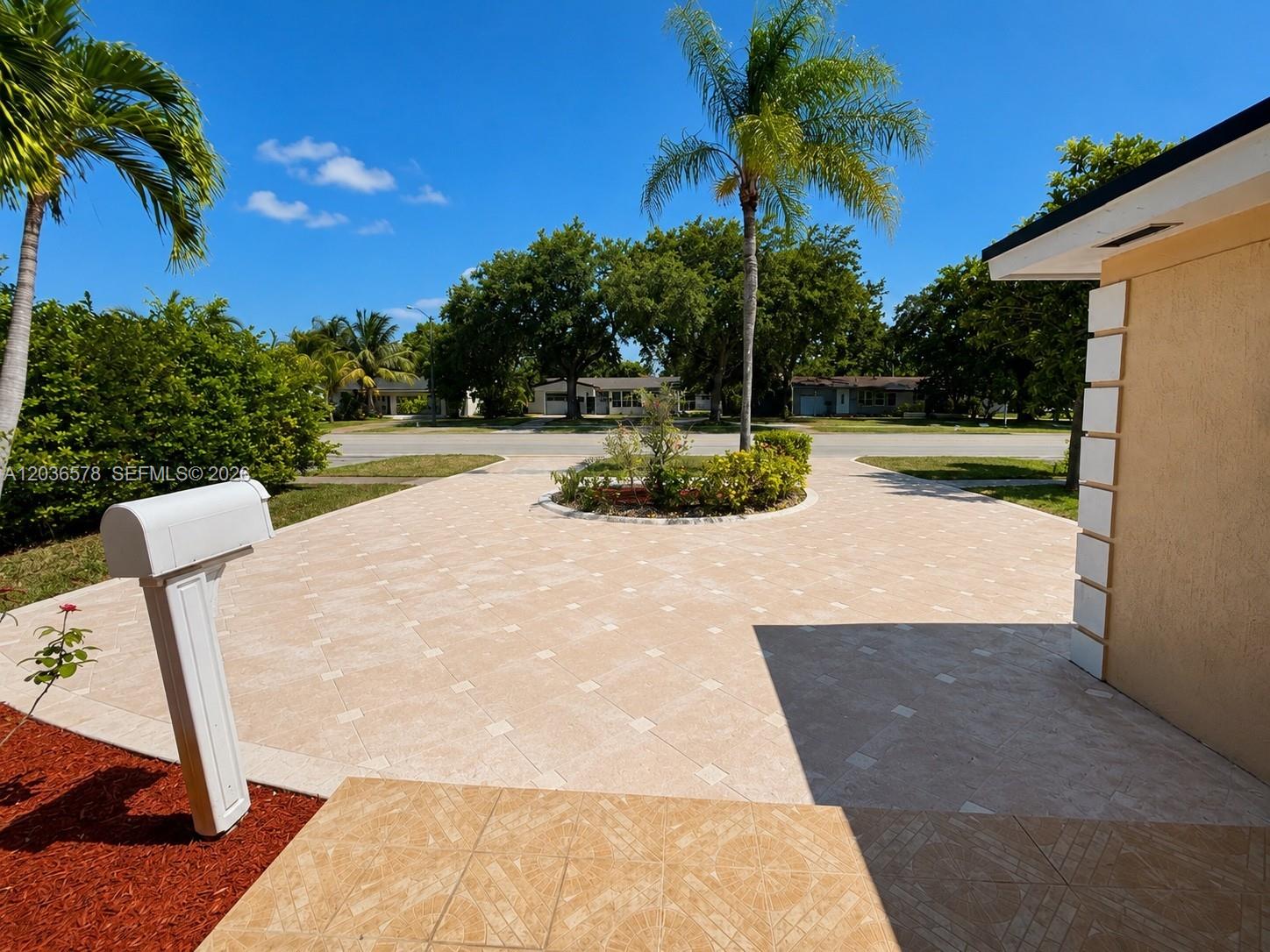A paved driveway leads to a circular garden bed in front of a residential home — 3327 Taft St, Hollywood FL 33021, HOLLYWOOD, FL