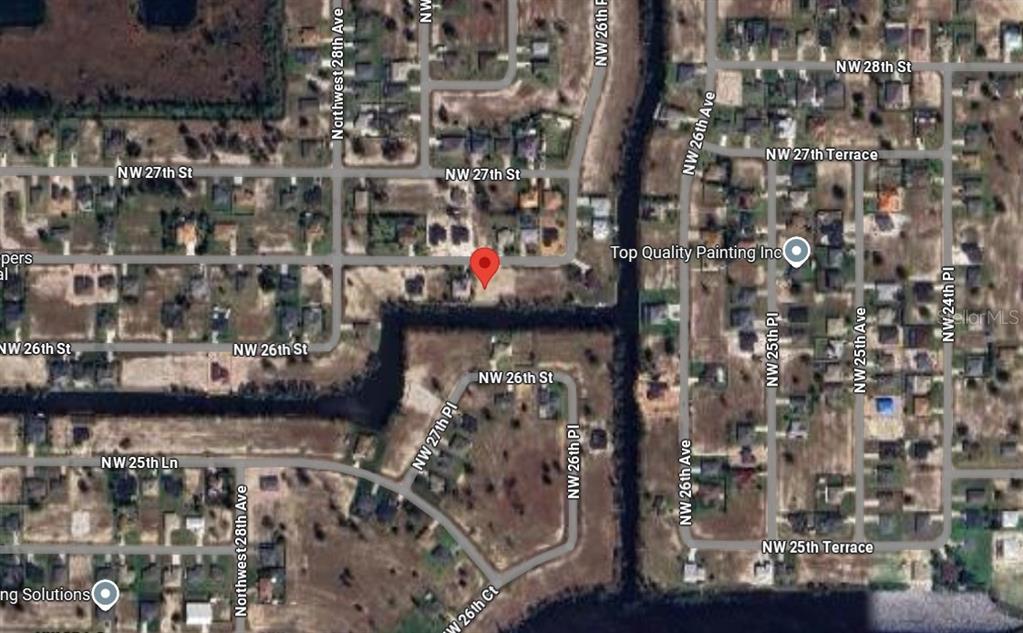 This is a satellite map view of a residential neighborhood with a red location pin — 2614 NW 26TH TERRACE, CAPE CORAL, FL
