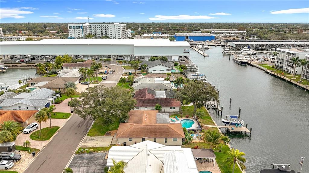 An aerial view shows waterfront homes with swimming pools along a canal near a marina — 3828 48TH AVENUE S, ST PETERSBURG, FL