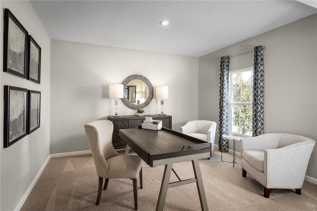 A home office features a dark wood desk, two armchairs, and a console table with lamps — 1158 HICKORY BRANCH DRIVE, LAKELAND, FL