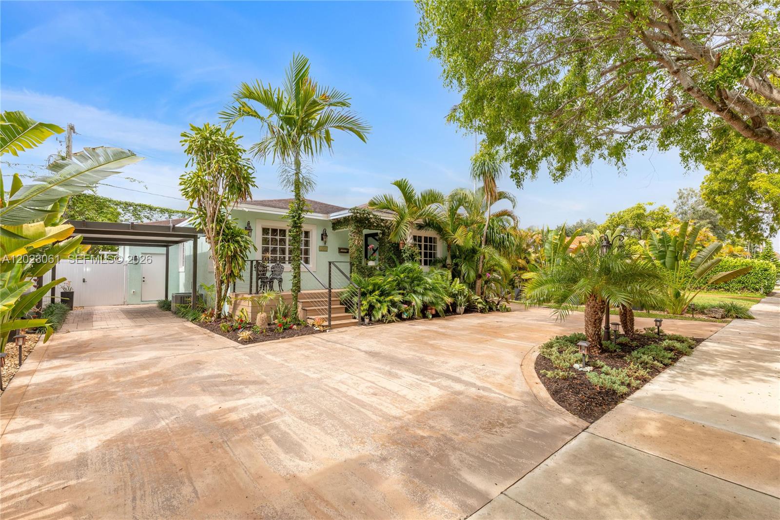 A light green house with a palm-filled front yard and a concrete driveway — 6520 SW 16th Ter, West Miami FL 33155, WEST MIAMI, FL