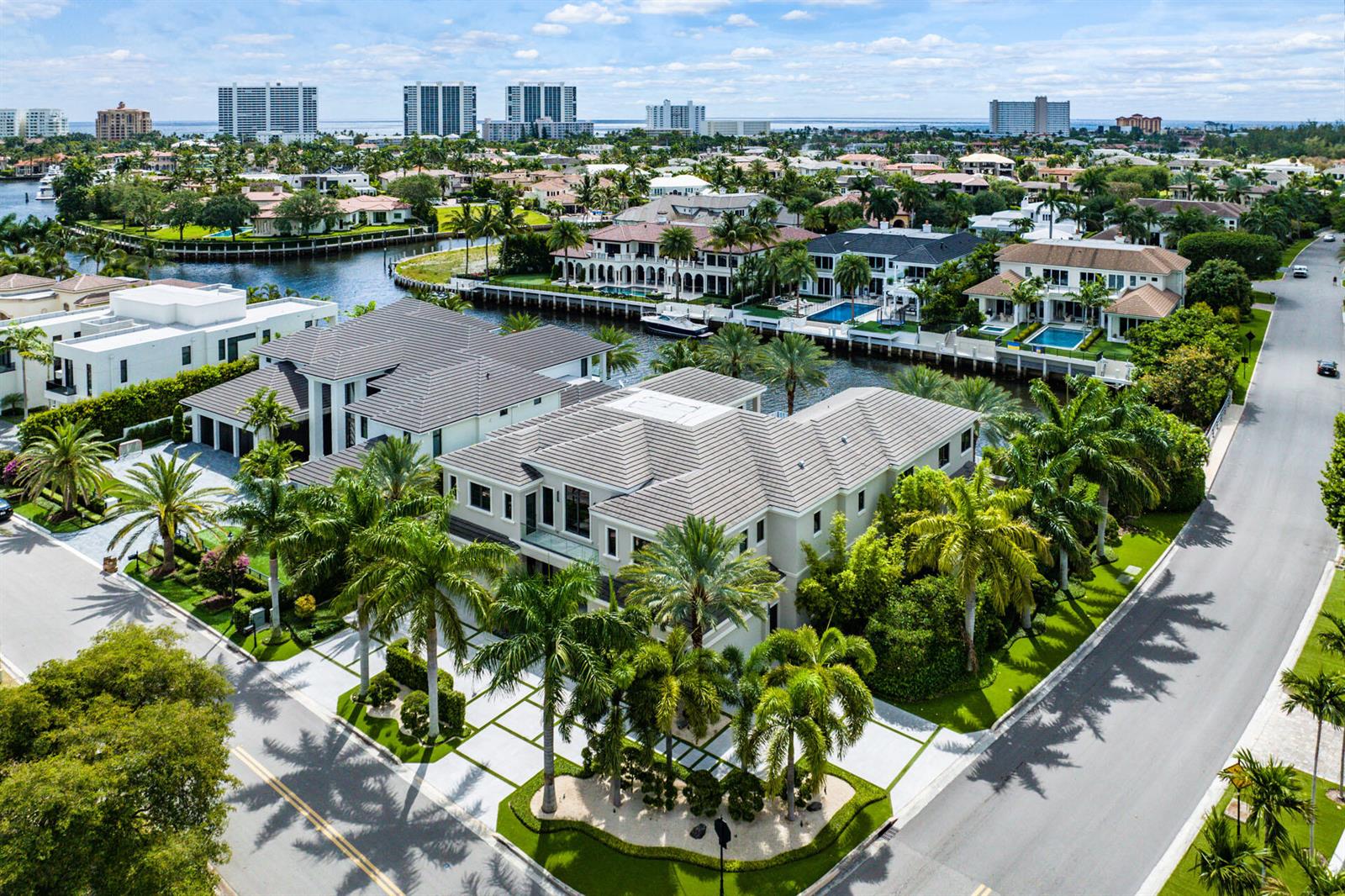 An aerial view of a large, modern multi-story house with a tiled roof and palm trees — 290 S Maya Palm Drive, Boca Raton FL 33432, BOCA RATON, FL