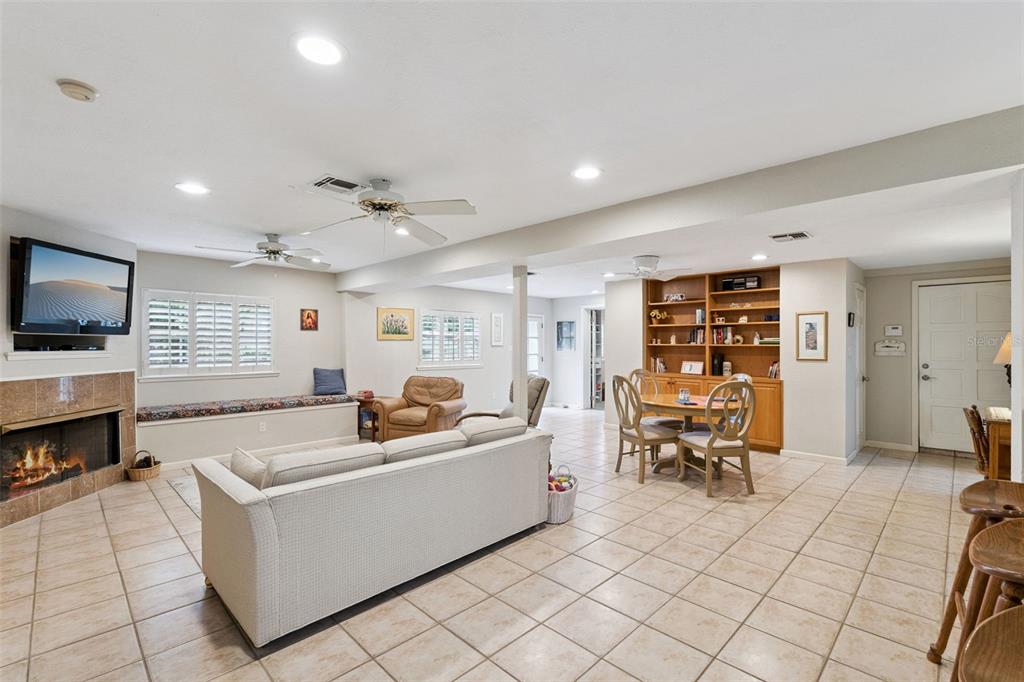 A wooden front door with a glass window sits at the end of a hallway — 1008 E RIDGEWOOD ST, ORLANDO, FL