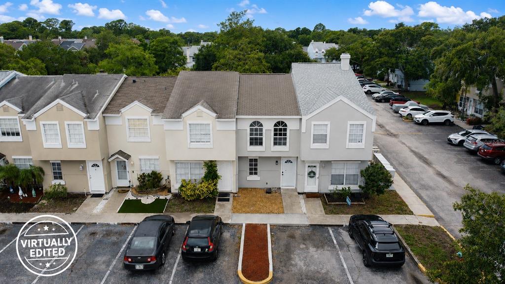 An aerial view shows a row of townhouses with parking spaces in front — 6661 121ST AVENUE UNIT G, LARGO, FL