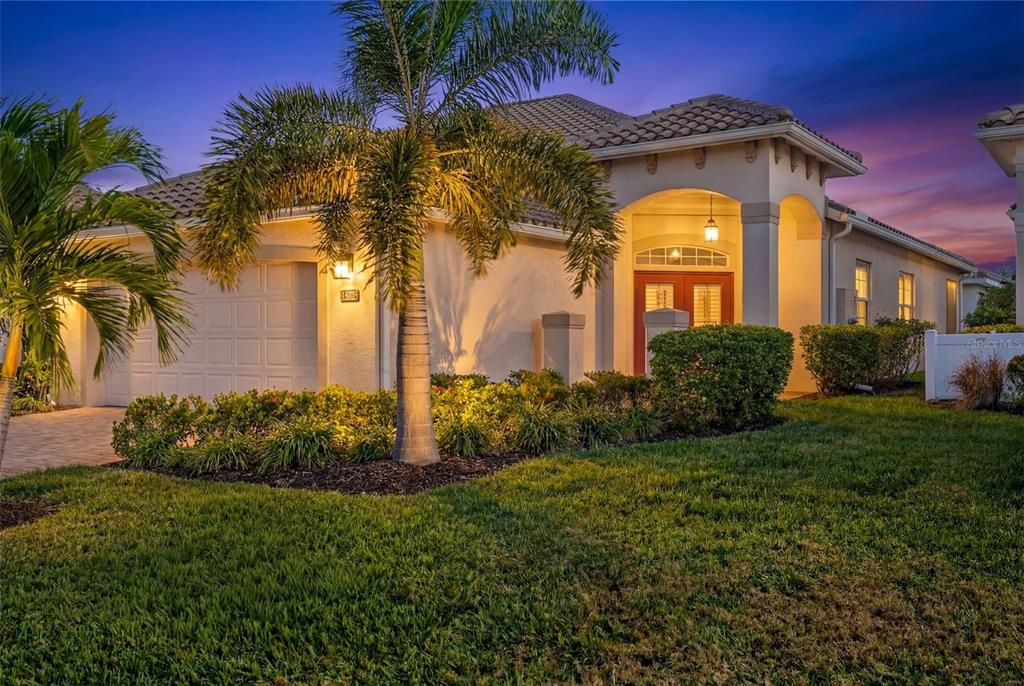 A single-story house with a palm tree, a two-car garage, and a covered entryway — 15233 CAPE SABLE LANE, FORT MYERS, FL