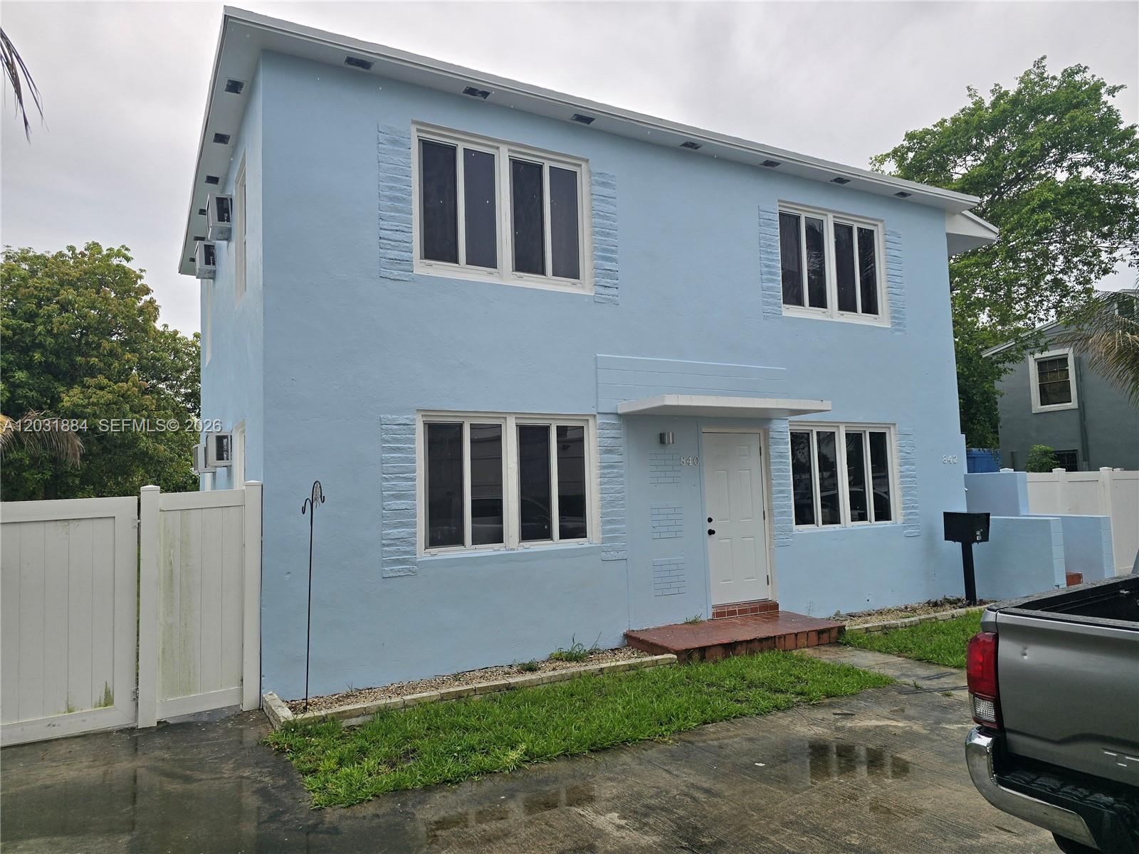 A two-story light blue house with white trim and a concrete driveway — 840 NE 124th St # B, North Miami FL 33161, NORTH MIAMI, FL