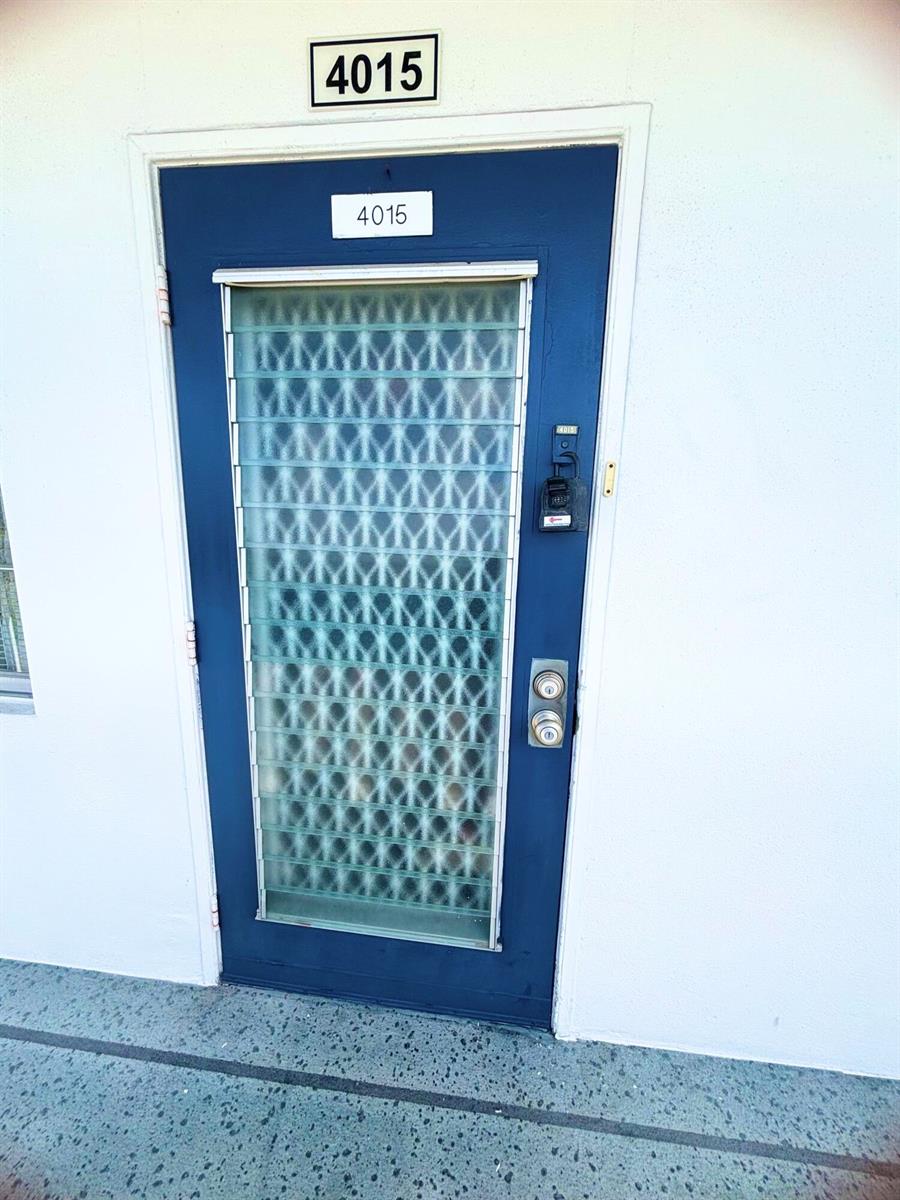 A blue exterior door with a glass jalousie window and a lockbox — 4015 Oakridge A # 4015, Deerfield Beach FL 33442, DEERFIELD BEACH, FL