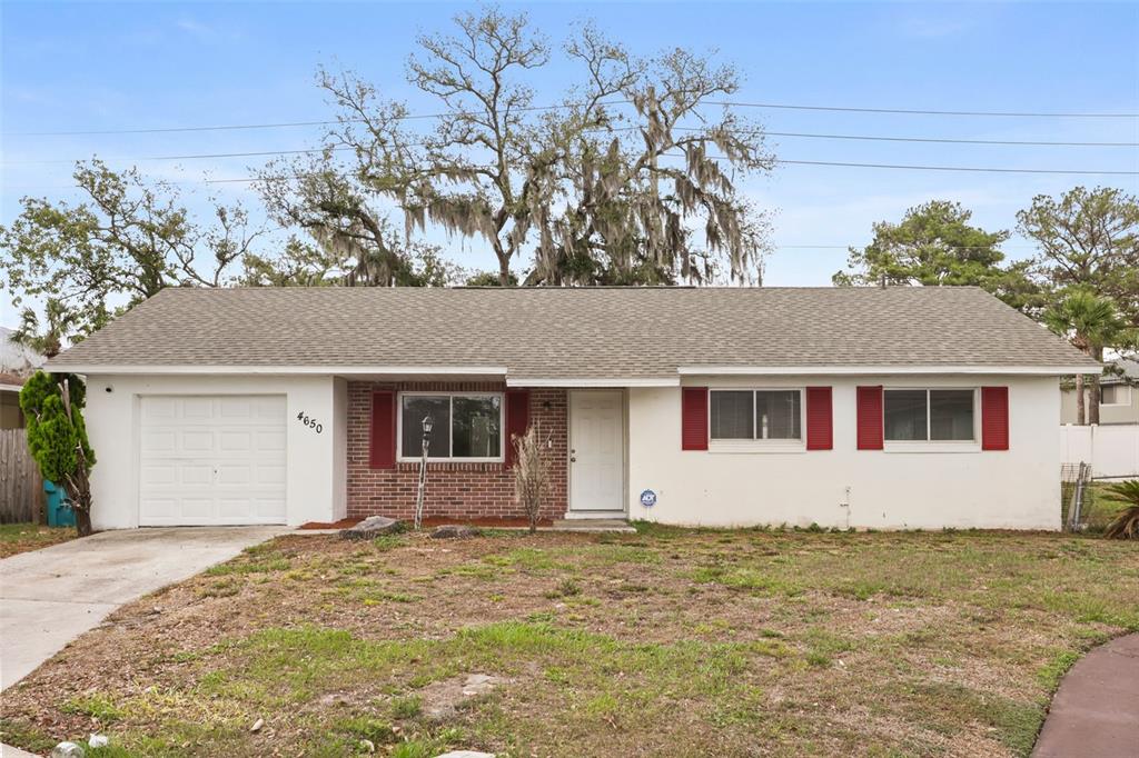 A single-story house with a brick facade, white siding, red shutters, and an attached garage — 4650 BOCA VISTA COURT, ORLANDO, FL