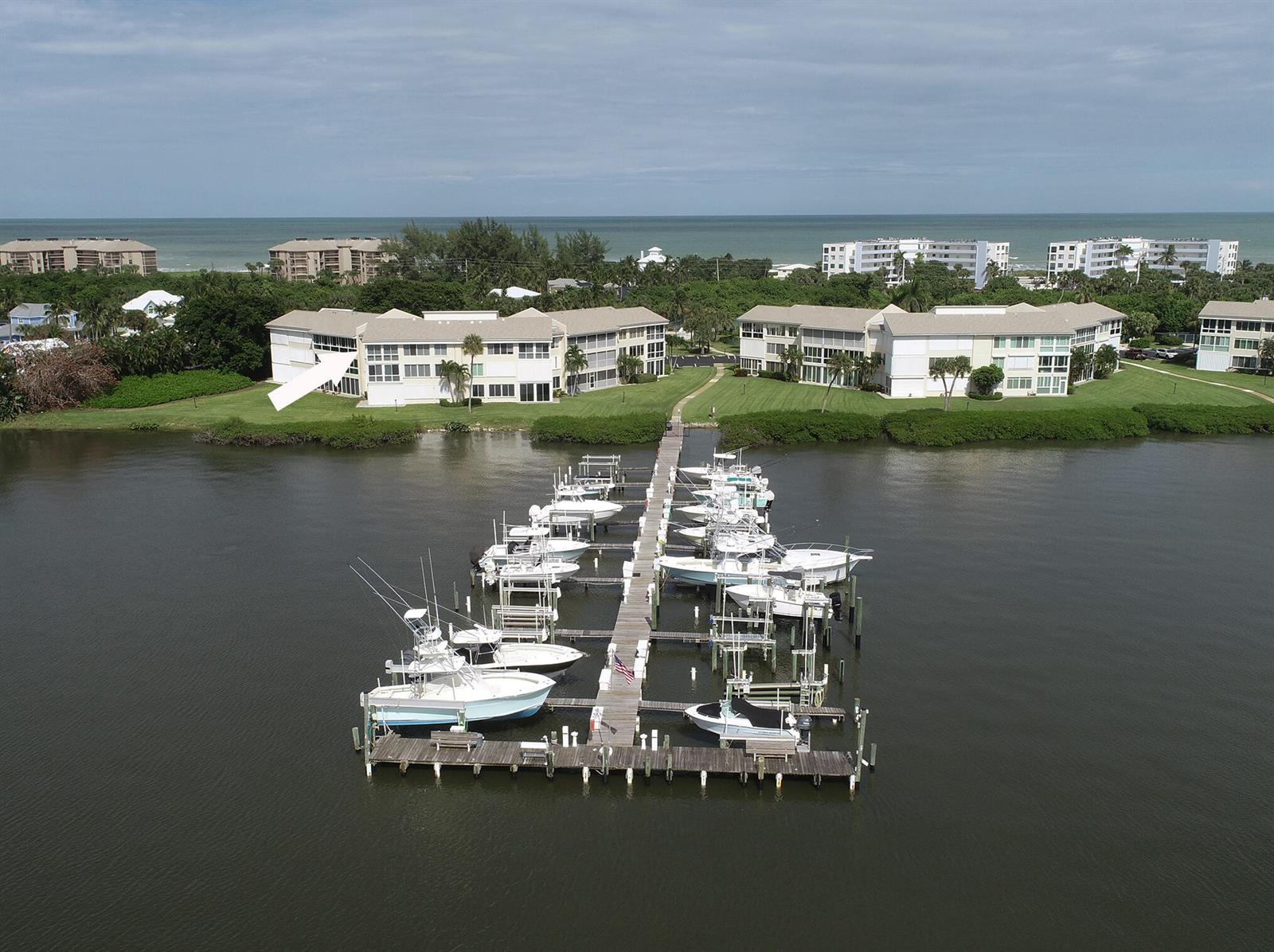 An aerial view of a waterfront condominium complex with a private boat dock and marina — 2370 NE Ocean Boulevard # C305, Stuart FL 34996, STUART, FL