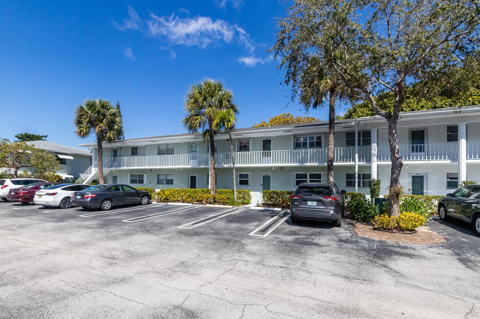 A two-story apartment building with a parking lot in front and palm trees — 2300 NW 22nd Avenue # 112, Delray Beach FL 33445, DELRAY BEACH, FL