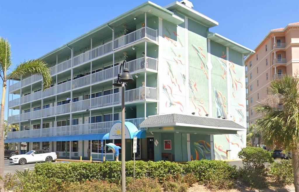 A multi-story teal hotel building with balconies and a mural on the side exterior wall — 504 S GULFVIEW BOULEVARD, CLEARWATER, FL