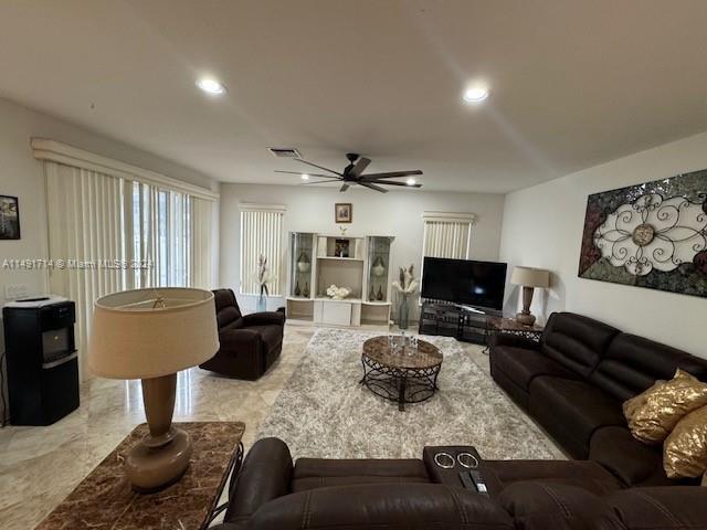 A living room features a brown leather sectional, a coffee table, and a ceiling fan — 3537 SW 175th Avenue, Miramar FL 33029, MIRAMAR, FL