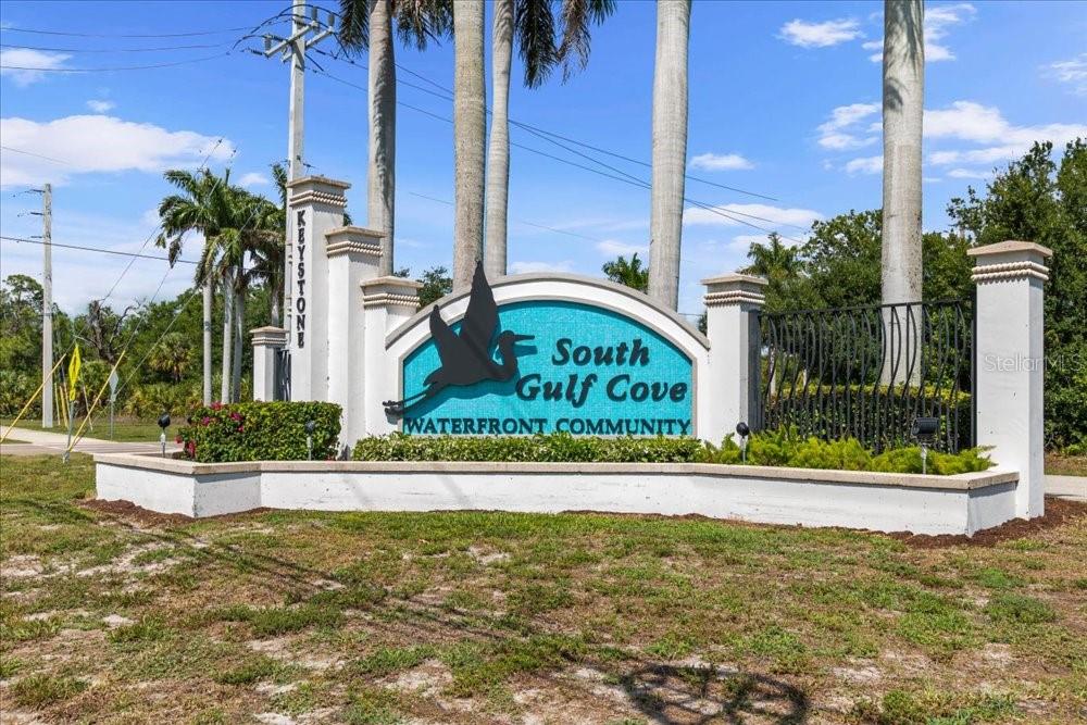 A sign for the South Gulf Cove waterfront community stands in a grassy area — 10120 WINNIPEG STREET, PORT CHARLOTTE, FL