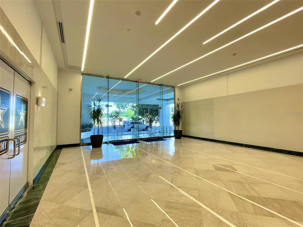 A modern lobby features a polished marble floor, recessed ceiling lighting, and glass entry doors — 654 MUÑOZ RIVERA, SAN JUAN, PR