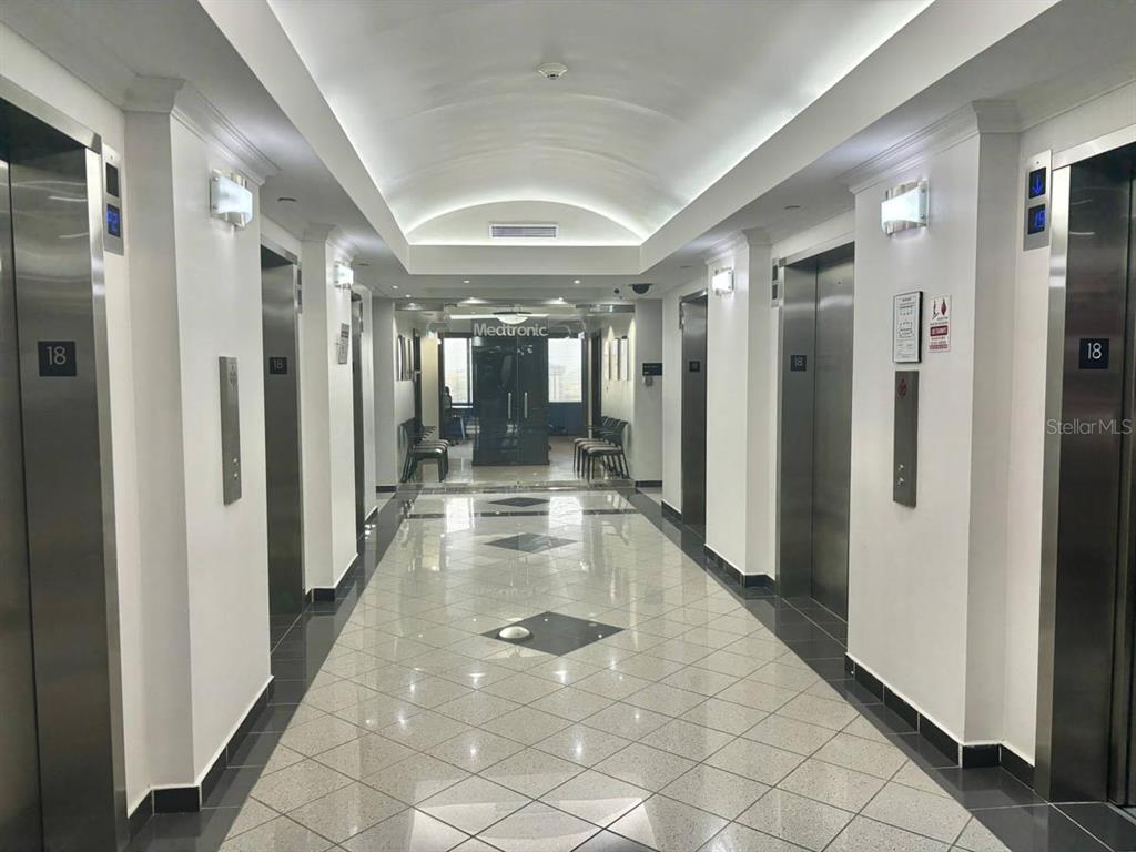 A commercial office building hallway features polished tile floors, multiple elevators, and a Medtronic entrance — 654 MUÑOZ RIVERA, SAN JUAN, PR