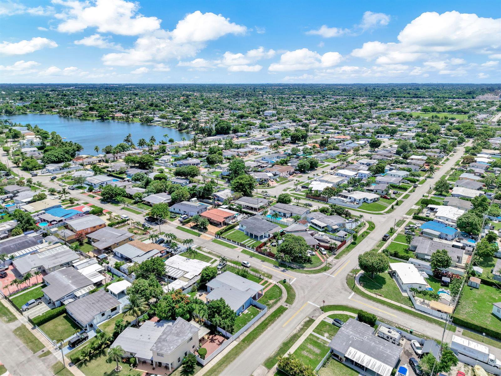 An aerial view of a suburban neighborhood featuring houses, streets, and a nearby lake — 4040 SW 108th Avenue, Miami FL 33165, MIAMI, FL