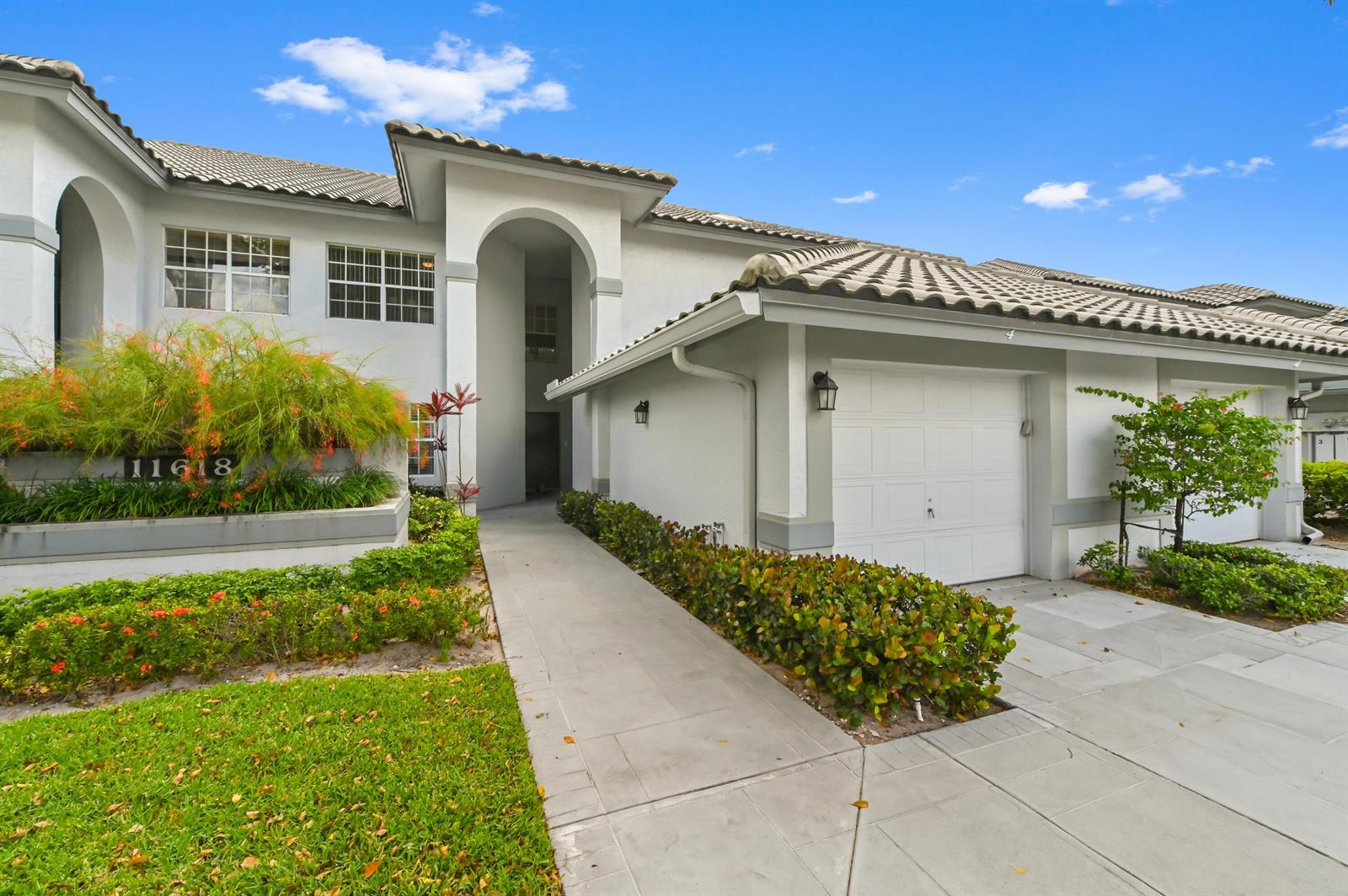 A two-story residential building with a white stucco facade, tiled roof, and attached garage — 11618 Briarwood Circle # 4, Boynton Beach FL 33437, BOYNTON BEACH, FL