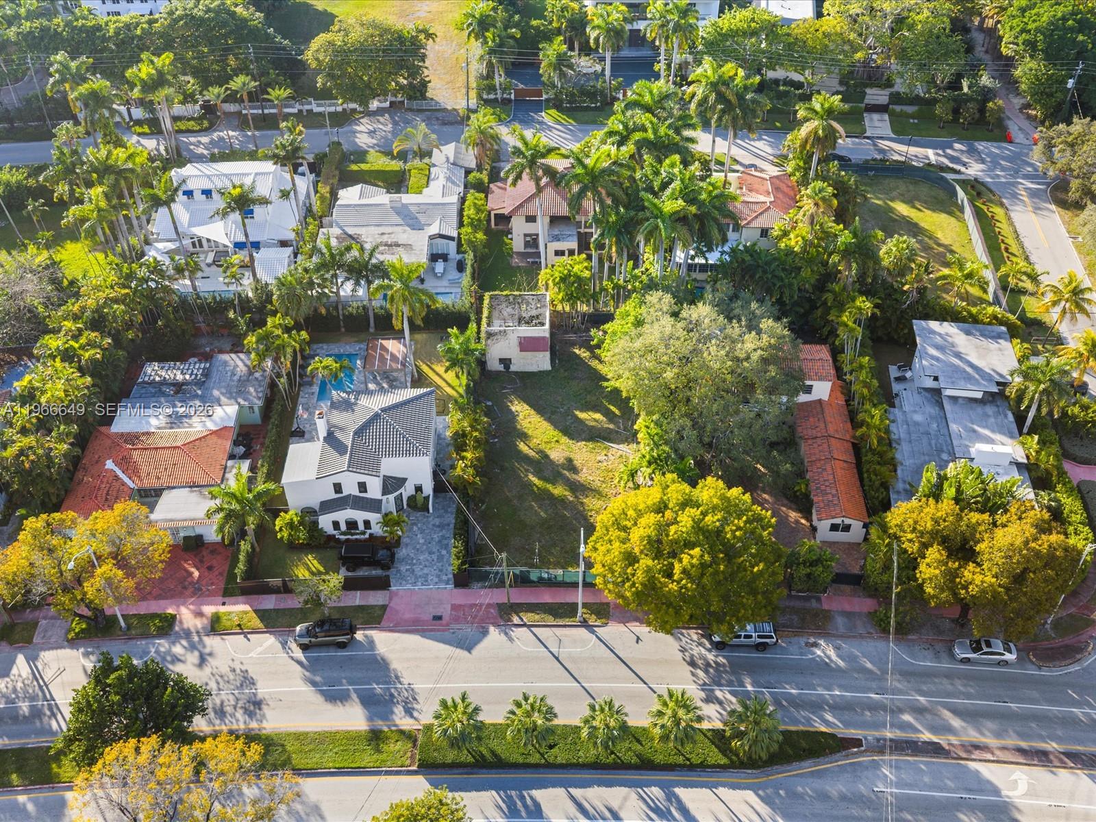 An aerial view shows several houses, a vacant lot, and palm trees along a street — 5838 Alton Rd, Miami Beach FL 33140, MIAMI BEACH, FL