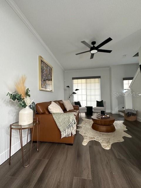 A living room features a brown leather sofa, wood-look flooring, and a ceiling fan — 107 BRADFORD BEACH COURT UNIT 107, TAMPA, FL